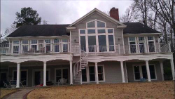 Large Open Field Home with Brown Roof